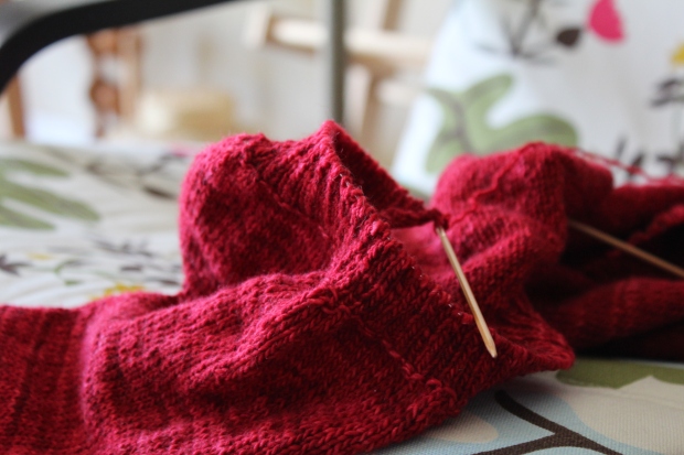 Red knitted sweater in progress