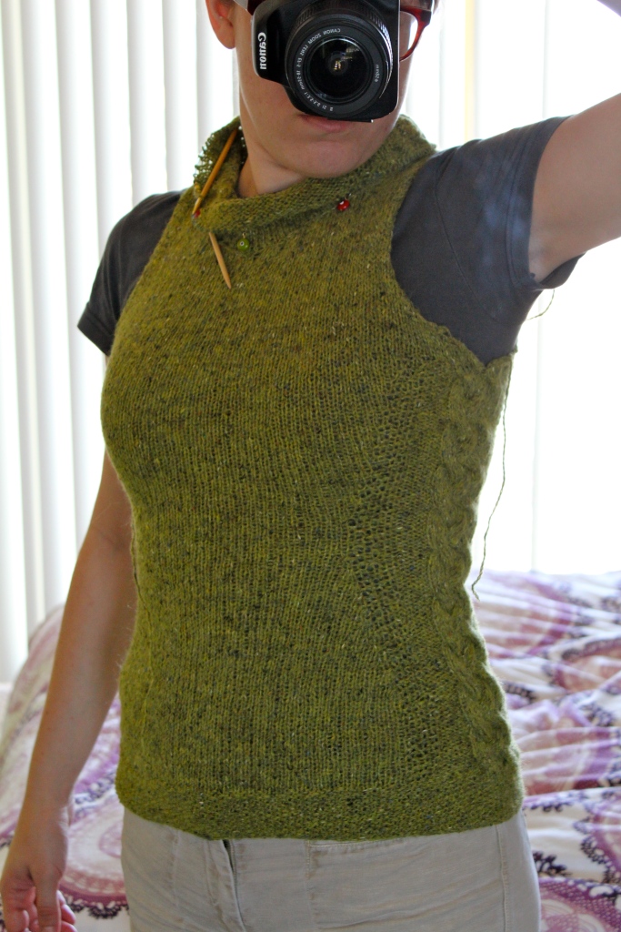 Woman wearing a green cowl-necked vest