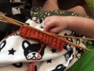 Cuff of a Rick and Roll sock by Hands Occupied with a baby hand